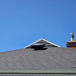 Solar attic ventilation fan installed on a shingle roof