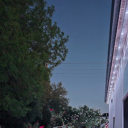Roofline lighting glowing along the eaves at dusk